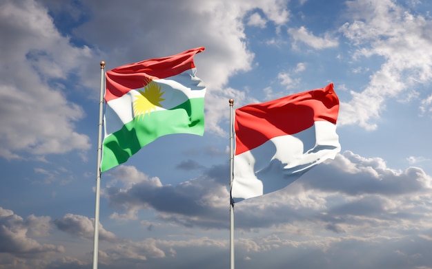 Beautiful national state flags of Kurdistan and Indonesia together on blue sky