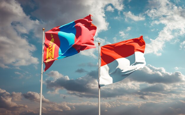 Beautiful national state flags of Mongolia and Indonesia together on blue sky