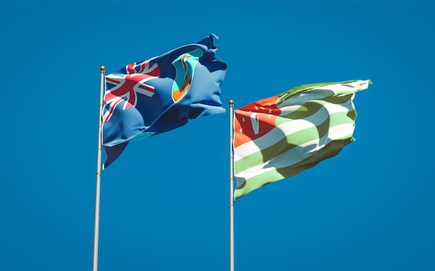 Beautiful national state flags of Montserrat and Abkhazia together on blue sky. 3D artwork