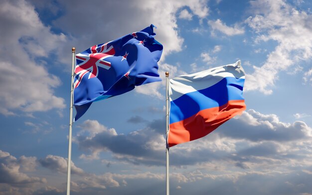 Beautiful national state flags of New Zealand and Russia together on blue sky. 3D artwork