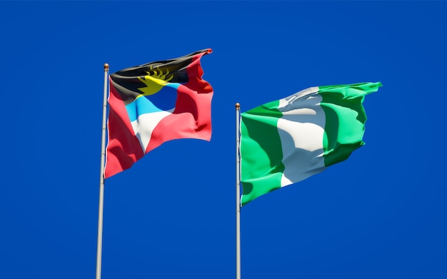 Beautiful national state flags of Nigeria and Antigua and Barbuda together on blue sky