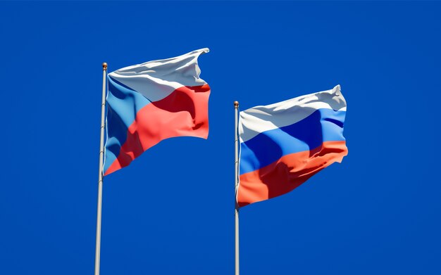 Beautiful national state flags of Russia and Czech together on blue sky. 3D artwork