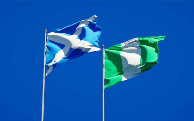 Beautiful national state flags of Scotland and Nigeria together on blue sky