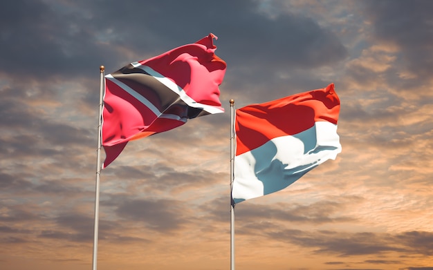 Beautiful national state flags of Trinidad and Tobago and Indonesia together on blue sky