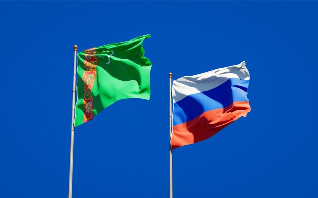 Beautiful national state flags of Turkmenistan and Russia together on blue sky. 3D artwork