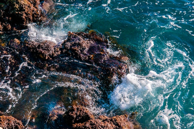 Beautiful natural rock of Australian beach. Amazing blue green sea and sunny windy day.