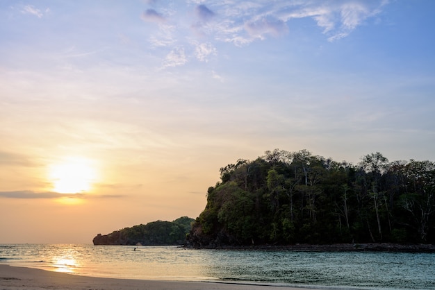 Beautiful nature landscape of colorful the sun on the sky at Tarutao island beach during the sunset over the Andaman Sea, Tarutao National Park, Satun, Thailand