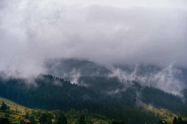 Beautiful nature landscape with rainy clouds above mountains