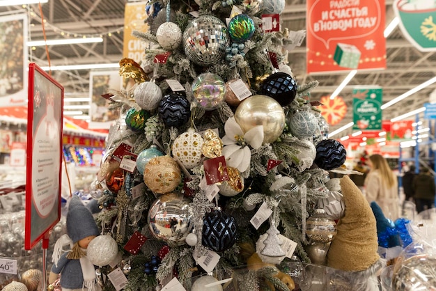 Beautiful New Year's decoration of the supermarket. Sale of Christmas trees, toys and decorations. Close-up. Moscow, Russia, 12-17-2021.