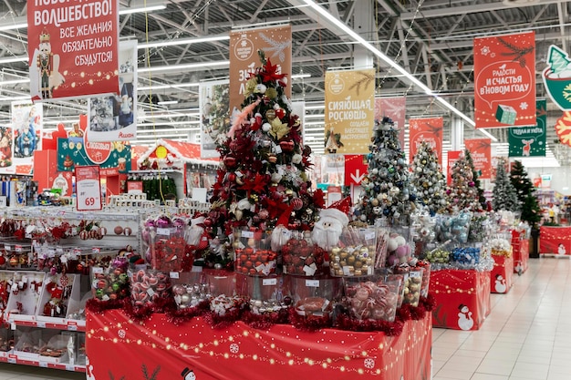 Beautiful New Year's decoration of the supermarket. Sale of Christmas trees, toys and decorations. Moscow, Russia, 12-17-2021.