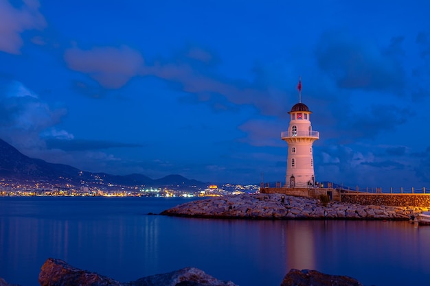 Beautiful night shot of the lighthouse on the pier in the old town of Alanya