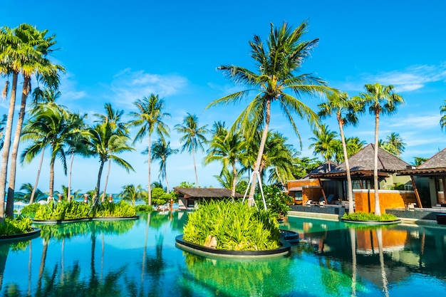 Beautiful outdoor swimming pool with coconut palm tree