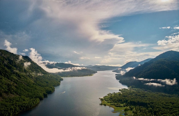 Beautiful panoramic landscape above clouds and mountains with sun rising in the middle