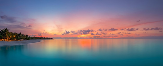 Beautiful panoramic sunset tropical paradise beach. Tranquil summer vacation or holiday landscape