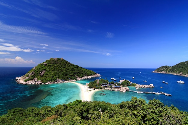 Beautiful panoramic view of tropical island against blue sky with clouds