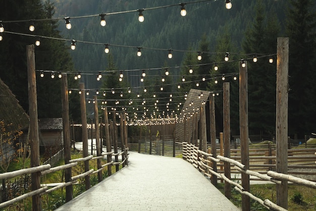 Beautiful park in mountain resort with cozy bulbs