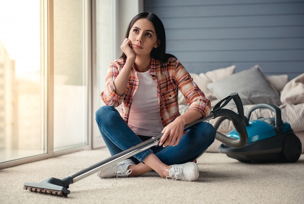 Beautiful pensive young woman is looking away. Cleaning concept