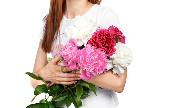 beautiful peonies in the hands of a girl on a white background closeup