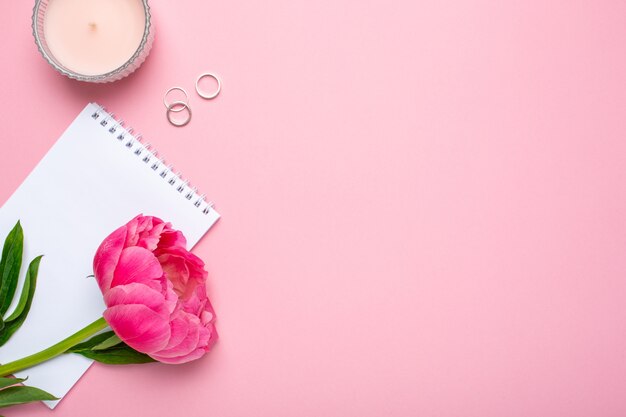 Beautiful pink peony flower and notebook