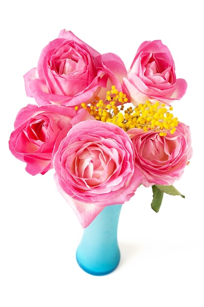 Beautiful pink roses and mimosa bunch in vase