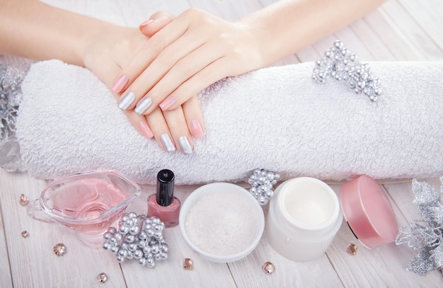 Beautiful pink and silver christmas manicure with spa essentials