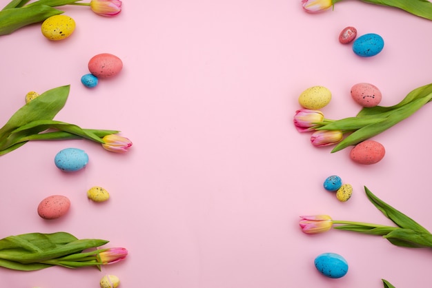 Beautiful pink tulips and colored Easter eggs.