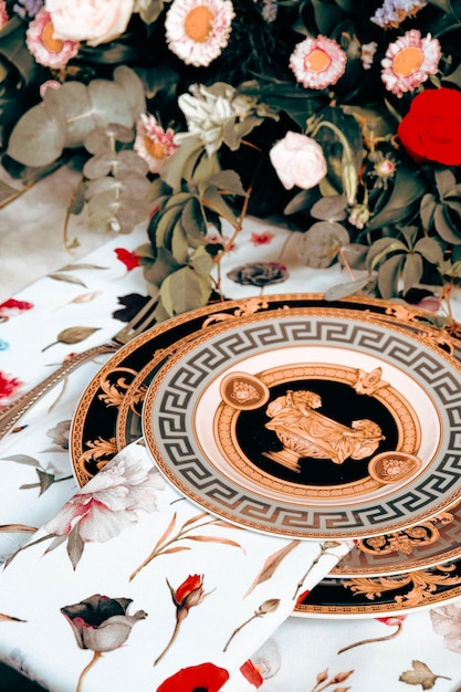 beautiful plate and fresh perfect colorful flowers standing on luxury table