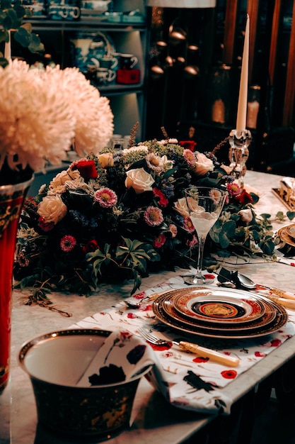 beautiful plate and fresh perfect colorful flowers standing on luxury table