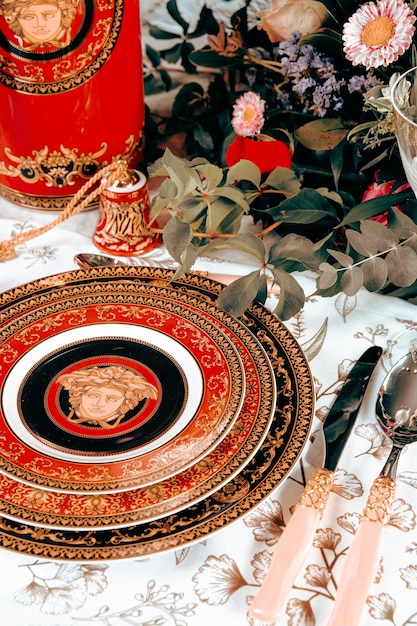 beautiful plate and fresh perfect colorful flowers standing on luxury table