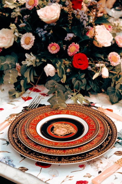 beautiful plate and fresh perfect colorful flowers standing on luxury table