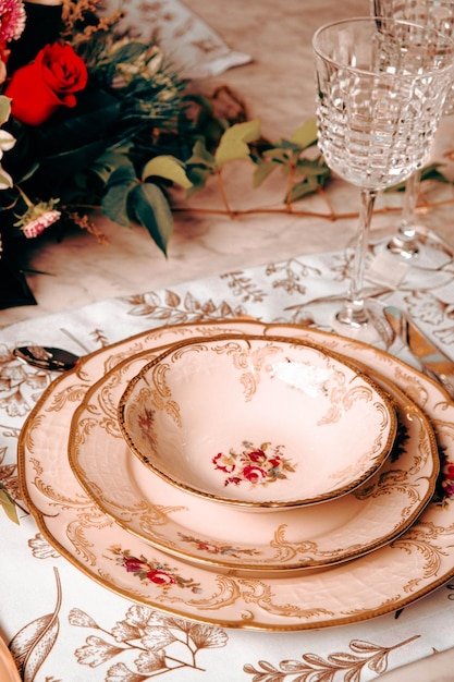 beautiful plate and fresh perfect colorful flowers standing on luxury table