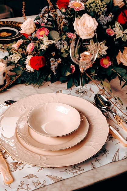 beautiful plate and fresh perfect colorful flowers standing on luxury table