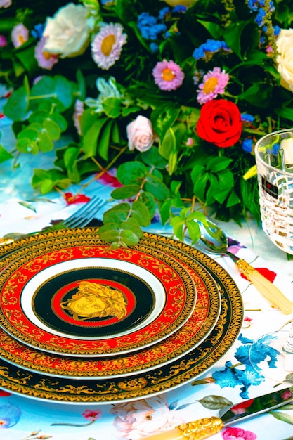 beautiful plate and fresh perfect colorful flowers standing on luxury table