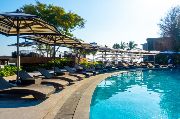 beautiful pool chair bed and umbrella around swimming pool in hotel resort