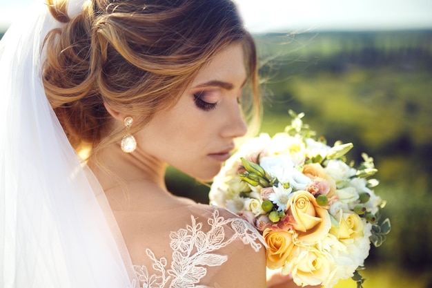 A beautiful portrait of the bride under a veil Woman with professional make up and hair style