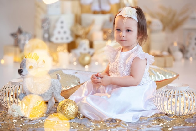 beautiful portrait of a smiling baby girl on a shiny background