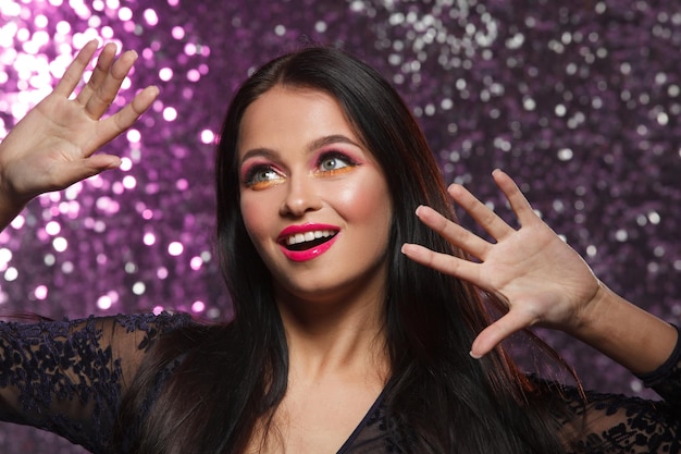 beautiful portrait of a smiling girl on a shiny background