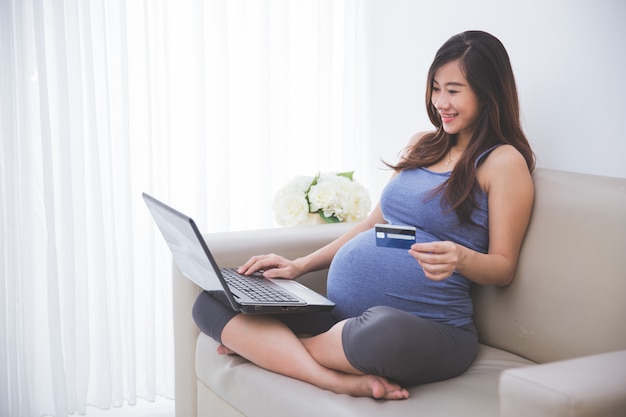 Beautiful pregnant woman buying stuff online