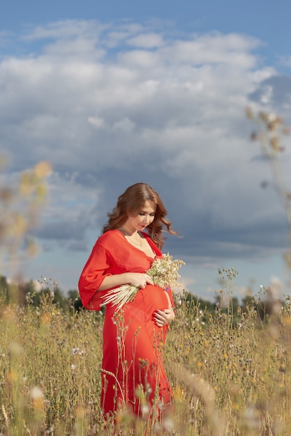 Beautiful pregnant woman outdoors