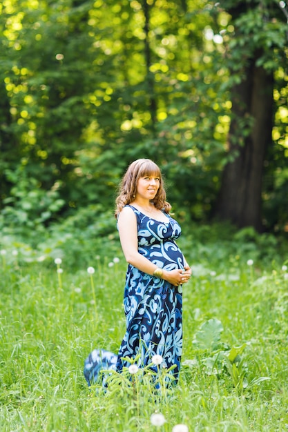 Beautiful pregnant woman relaxing outdoors