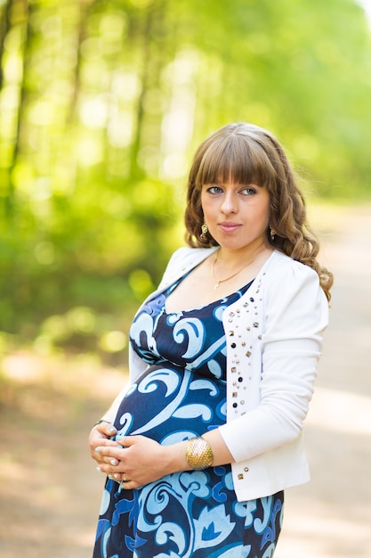 Beautiful pregnant woman relaxing outdoors