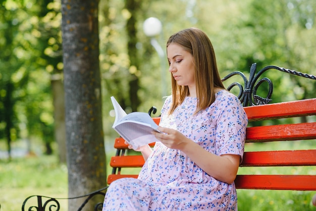 Beautiful pregnant woman relaxing in the park