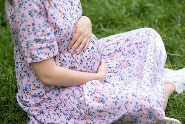 Beautiful pregnant woman relaxing in the park