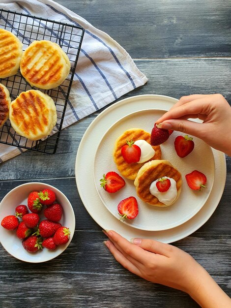 A beautiful presentation of a morning snack of cheesecakes with strawberries