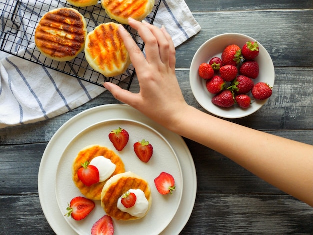 A beautiful presentation of a morning snack of cheesecakes with strawberries