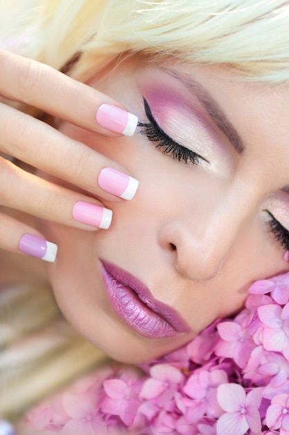 Beautiful purple makeup and French manicure