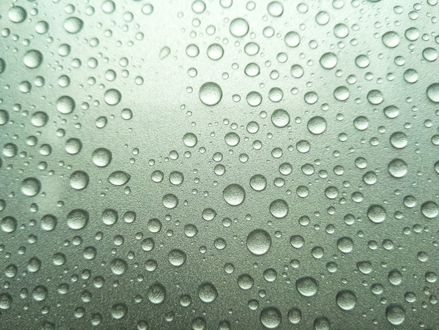 Beautiful rain dew on the top of the car.