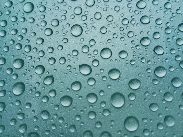 Beautiful rain dew on the top of the car.