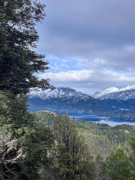 Beautiful range of snowy mountains and a lake with blue sky above in Bariloche Argentina amazing panoramic view at Circuito Chico Patagonia