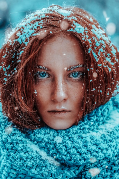 Beautiful redhead woman portrait in snow